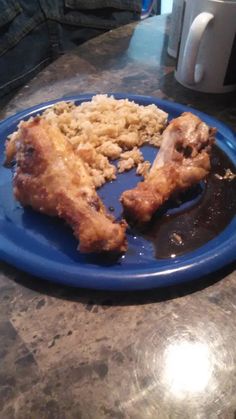 a blue plate topped with fried chicken and rice