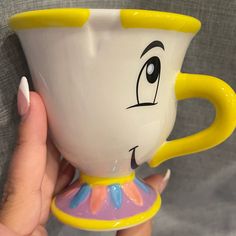 someone holding up a beauty and the beast coffee cup with their face painted on it