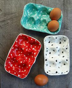 three bowls filled with eggs sitting on top of a wooden table