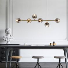 a dining room table with four stools and a chandelier hanging from the ceiling