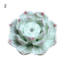 a close up of a flower shaped object on a white background with the number 2 below it