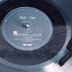 an old record is sitting on top of a metal plate with the word sza cut