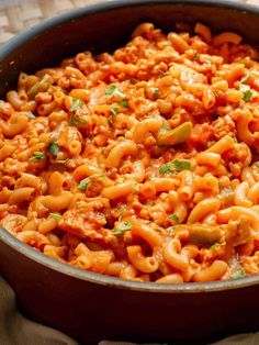 a pot filled with pasta and sauce on top of a table