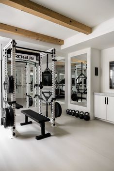 a home gym with weight machines and exercise equipment in the center, on white flooring