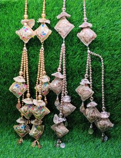 several different types of necklaces and earrings on the grass in front of some green grass