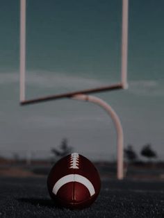 a football sitting on top of a field next to a basketball hoop