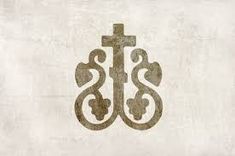 a cross and two snakes are on top of a white paper with the word jesus written in it