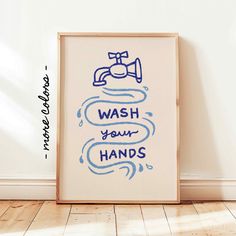 a blue and white poster with the words wash your hands on it in front of a wall