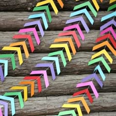 colorful paper arrows are lined up on wooden planks