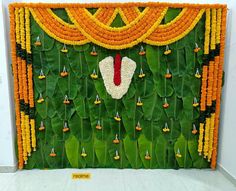 a green wall decorated with flowers and leaves