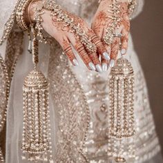 a close up of a person's hands with jewelry on them