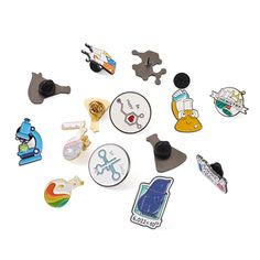 various pins and magnets on a white surface