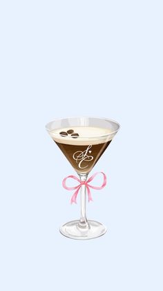 a martini glass with a bow on the side and monogrammed initials in it