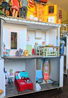 a doll house with dolls on top of it