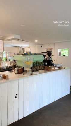 a kitchen with white cabinets and counter tops