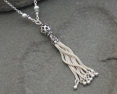 "This necklace features a Turkish Sterling Silver Filigree Tassel securely wire wrapped to a long sterling chain. I added some coordinating Turkish and sterling silver beads into the wire wraps for an extra accent. This tassel necklace is classic, elegant and fun. Can easily be dressed up or worn casually. The chain measures 30\" and the pendant hangs about 3\" from that. No clasp necessary as the long chain fits right over your head. Sterling Silver is .925 pure silver. Bali silver is .925 pure Layered Necklaces Silver, Bali Silver, Silver Chain Style, Tassel Jewelry, Chain Silver, Sterling Silver Filigree, Layering Necklace, Classic Elegant, Beads And Wire