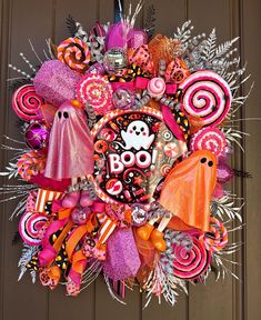 a halloween wreath with candy and decorations on the front door