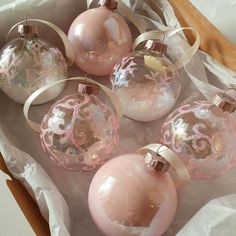 pink and white glass ornaments in a box