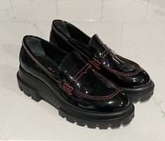 Elevate your shoe game with these stylish and comfortable AGL penny loafers. Crafted in Italy with high-quality materials, these black patent leather shoes feature a mid-height block heel and a slip-on closure for easy wear. The red stitching accents add a touch of designer flair to these versatile loafers, making them perfect for both casual and formal occasions. The shoes are available in women's UK shoe size 2, US shoe size 5, and EU shoe size 35. The lining material is made of leather, while the insole is also crafted from leather for added comfort. The outsole is made of rubber, making it durable and long-lasting. These AGL penny loafers are a must-have for any fashion-forward woman looking for a comfortable and stylish shoe. Thanks for looking and be sure to follow as new items are l Loafers For Women Socks, Patent Leather Platform Shoes, Heeled Loafers Uk, Womens Loafers Size 11, Channel Loafers Shoes, Walmart Loafers, Loafers Uk, Black Patent Leather Shoes, Patent Leather Shoes