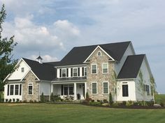 a large white house sitting on top of a lush green field