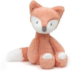 a small stuffed fox sitting on the ground with it's eyes closed and ears wide open