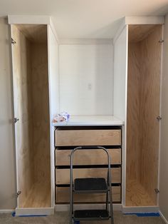 an empty room with some shelves and a chair in it's corner next to the closet doors