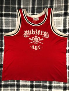 a red shirt that says subterd nyc with skulls and crossbones on it