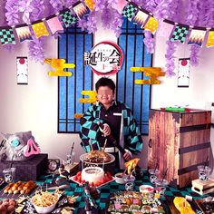 a man standing in front of a table filled with food and desserts on it