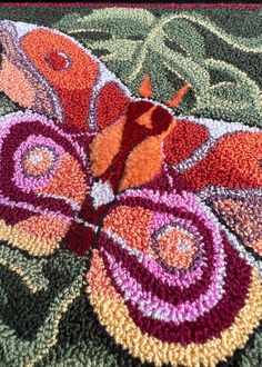 a close up of a colorful rug with flowers on it