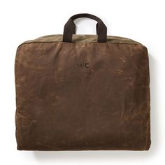 Made to keep your finer clothing protected in transit, this garment bag is crafted from waxed canvas, which ages beautifully as scratches and scuffs add to its unique patina. Features a pair of handles for easy carrying or hanging, plus a large outside zipper pocket for shoes and other accessories. Makes a great gift for groomsmen, jetsetting dads and recent grads. Add an embroidered monogram for a personal touch.    Fits two to three outfits.  22.5"w x 48"l  Exterior zipper pocket: 22.5"w x 11.5"h; Zipper opening: 19"w  Waxed canvas; antiqued brass hardware.  Spot clean only.  Imported.  Monogramming is embroidered. Gift For Groomsmen, Free Monogram, Mark And Graham, Embroidered Monogram, Antique Brass Hardware, Garment Bag, Aging Beautifully, Waxed Canvas, Monogram Gifts