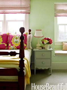 a bed room with a neatly made bed and two windows