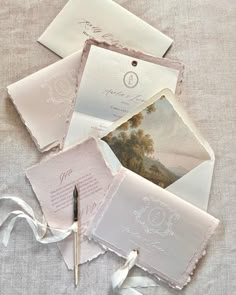 wedding stationery and envelopes laid out on linen