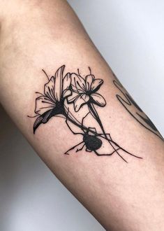 a black and white flower tattoo on the arm