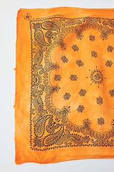 an orange bandana with black designs on it