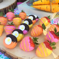 some strawberries and chocolate covered strawberries on a wooden platter with other desserts