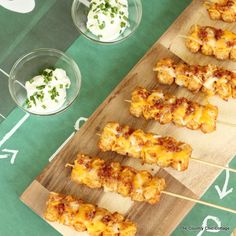 chicken skewers with ranch dressing on a football field tablecloth, ready to be served