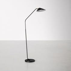 a black floor lamp sitting on top of a table