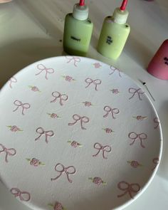 the table is decorated with pink bows and green bottles