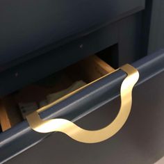 a close up of a door handle on a blue cabinet with money in the drawer