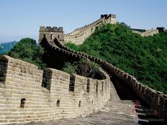 the great wall of china with an orange sign on it that says let's go