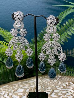 Rhodium plated earring with Cz stone work. About 4 inch long . American diamond push back super light weight. Carved stone detail. Clip back Carved Stone, Cz Earrings, Stone Work, American Diamond, Stone Carving, Cz Stone, Blue And Silver, Rhodium Plated, 4 Inch