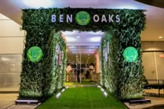 the entrance to ben oaks is decorated with greenery and lights for an event