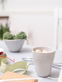 a white table topped with bowls filled with food