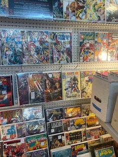 a bunch of comics are on display in a store