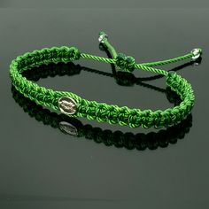 Fashionable And Durable Hand-Made Green String Bracelet With A Virgin Mary Charm For Wrist Sizes From 6 To 9 In. With An Easy To Use Zip Like Function To Fit Your Wrist, You'll Have It On As Soon As You Get It. Made From High-Quality Green String, It Will Be Sure To Last. Each Bracelet Is Carefully Handcrafted And Given Proper Time To Ensure Quality. Green Friendship Bracelets With Sliding Knot, Adjustable Green Bracelets, Green Adjustable Jewelry For Friendship, Elegant Adjustable Green Friendship Bracelets, Handmade Adjustable Green Rosary Bracelet, Adjustable Handmade Green Rosary Bracelet, Green Handmade Adjustable Rosary Bracelet, Green Beaded Jubilee Bracelet, Green Resizable Beaded Bracelets