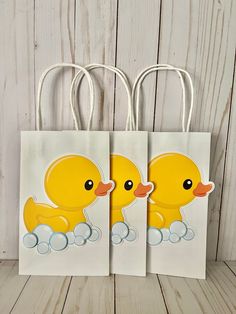 two yellow rubber ducks on white paper bags