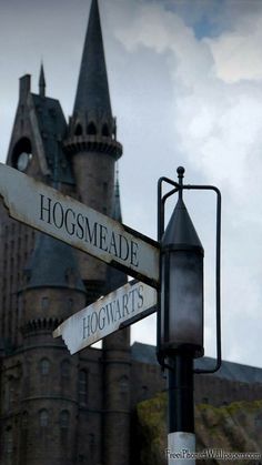 a street sign in front of a castle