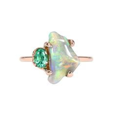 Through its supple display of florid color, a Black Opal makes a bold impression in this opal and emerald ring. Set in rose gold with an oval emerald, the Lightning Ridge Opal exudes an ethos of renewal. The chromatic flow pours forth from the apex of the opal, fanning out across the stone and depositing color along the way -- like a super bloom atop a widening expanse of the finest silt. The infusion of color leaving joy in its wake. Sourced from a mining family, this semi Black Opal is secured Luxury Green Oval Opal Ring, Luxury Green Opal Jewelry, Fine Jewelry Green Opal Ring, Green Opal Cabochon Ring, Super Bloom, Australian Opal Ring, Black Opal Ring, Lightning Ridge Opal, Claw Prong