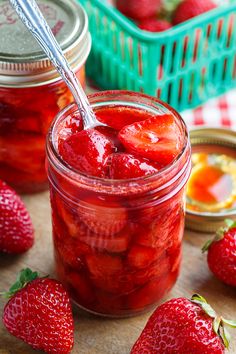 strawberry jam in a jar with strawberries on the side