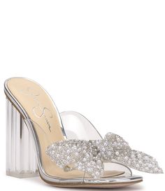 From Jessica Simpson&#x2C; the Saidah2 Pearl and Rhinestone Bow Clear Dress Sandals feature:Clear synthetic upperFaux pearl embellished oversized bowSquare toe constructionSlip on designSynthetic liningRubber outsoleApprox. 4.1" heel heightImported. Elegant Crystal Sandals For Spring, Crystal Heels For Spring Wedding, Spring Wedding Crystal Heels, Clear Sandals For Spring Wedding, Crystal Sandals For Formal Summer Events, Crystal Embellished Heels For Summer, Summer Formal Crystal Sandals, Spring Wedding Clear Sandals, Chic Clear Sandals For Wedding